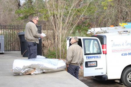 powers and gregory air conditioning technicians loading air conditioning van