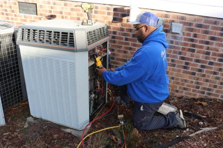 Powers and Gregory technician working on an HVAC unit. 