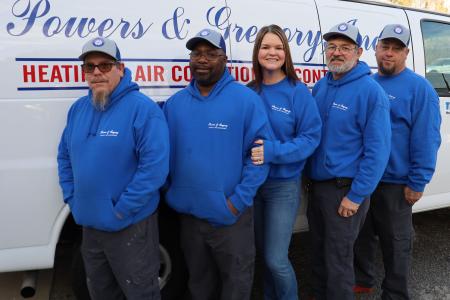 Powers and Gregory staff in front of work van. 